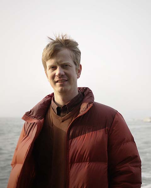 Seth Alberty in red jacket at the beach