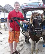 Seth Alberty standing next to horse buggy on Gili Island in Lombok, Indonesia