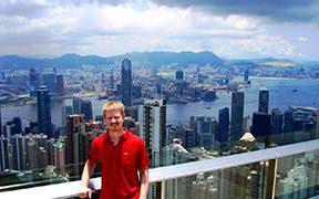 Seth Alberty standing on Victoria Peak in Hong Kong overlooking Hong Kong Harbour