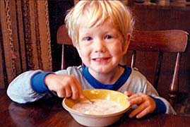 Seth Alberty as a young child eating his favorite dish: a bowl of cereal and milk